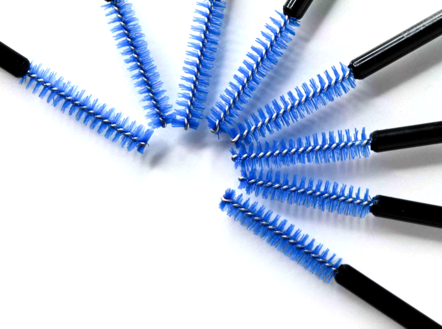 Close-up of 8 fiber brushes in a fan shape, blue bristles, black handles