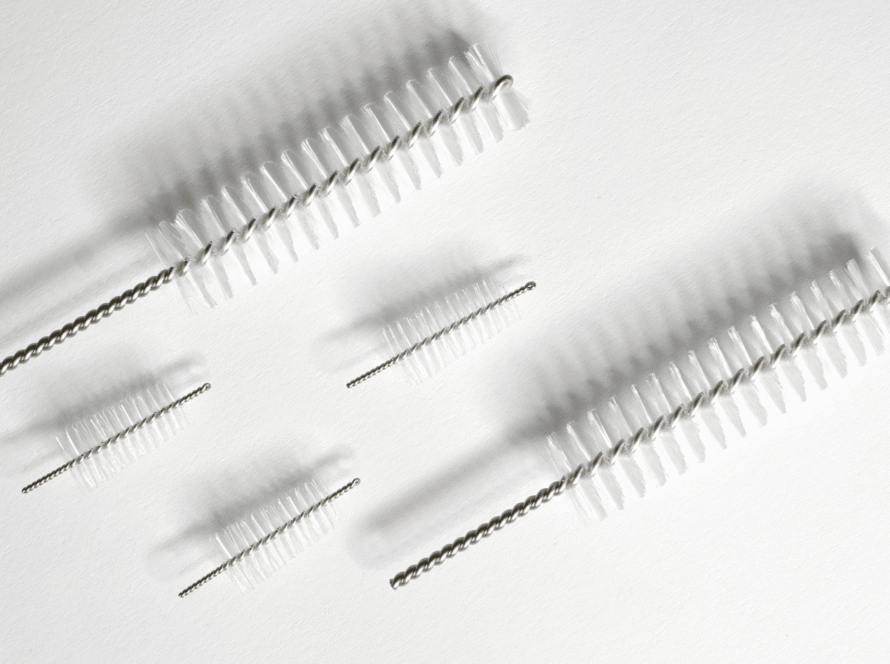 Two types of medical fiber brushes arranged on a white background
