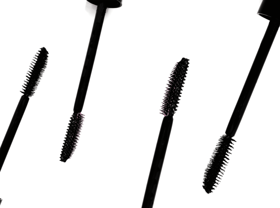 Different black fiber mascara brushes on a white background